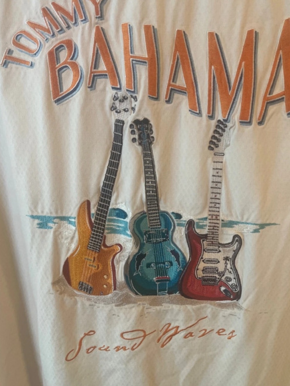 Tommy Bahama Cream Tee with Orange, Teal and Red Guitar Graphic Embroidery